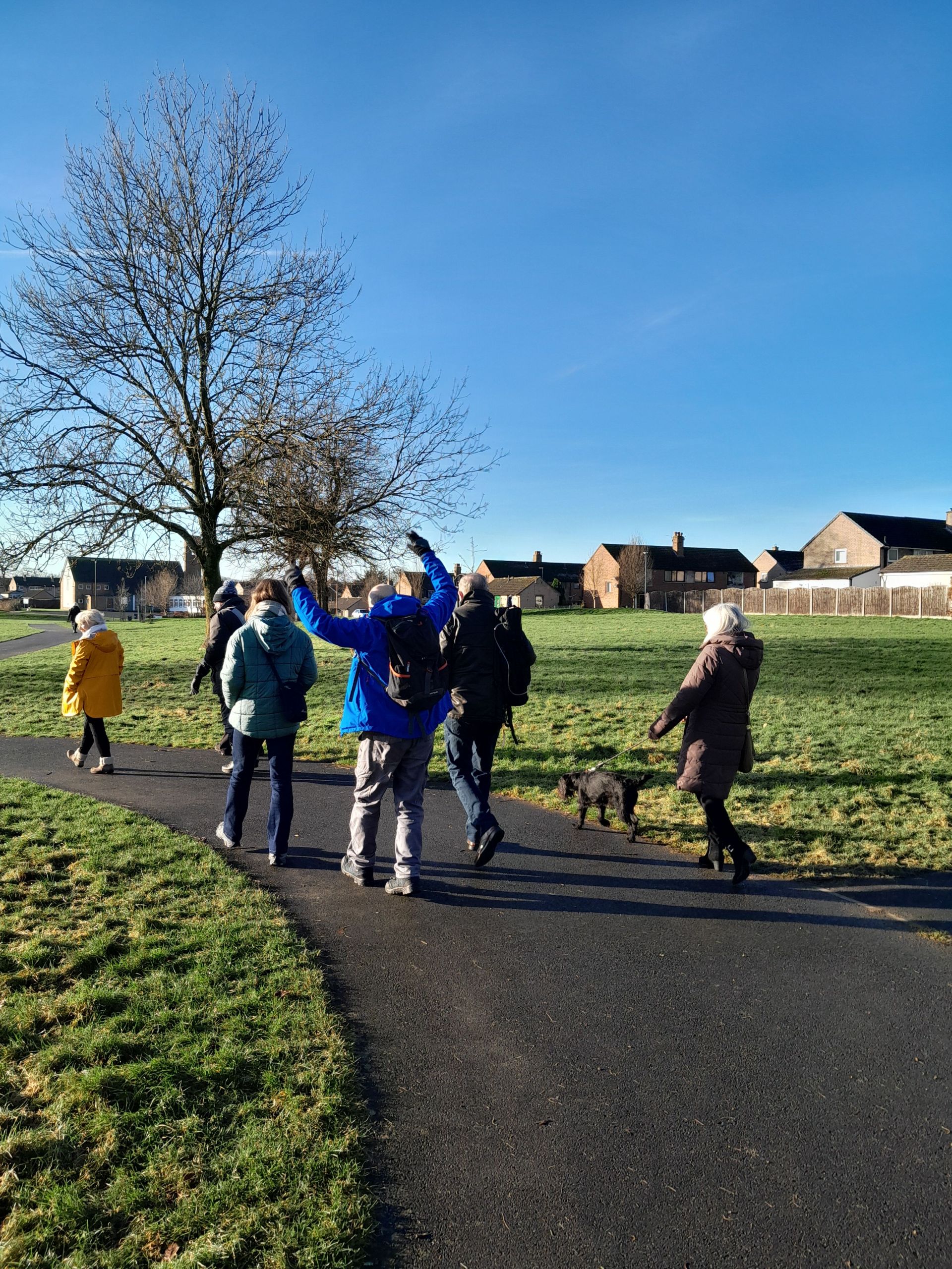 Group walking with dog at the back